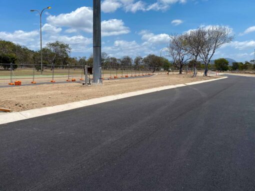 Newly constructed access road with street lighting and landscaped verges at the SunHQ Hydrogen Hub site.