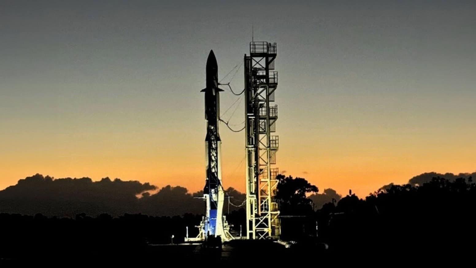 Launch vehicle on a pad at during sunrise.