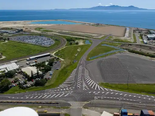 Aerial view of the Port of Townsville wind farm laydown area showing roads, hardstand and surrounding coastal landscape.