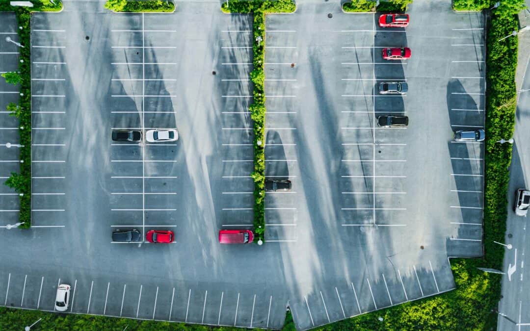 Aerial view of a car park with marked parking bays and landscaped areas.